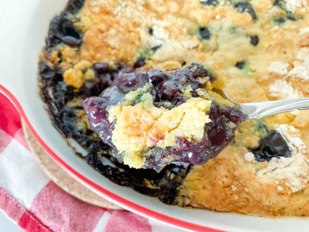 A spoonful of blueberry dump cake.