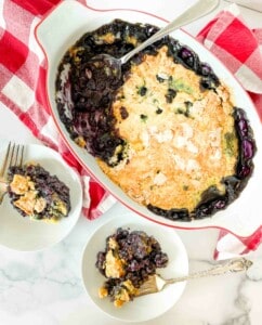 Plates with cake on them and the cake pan on a counter with linens..