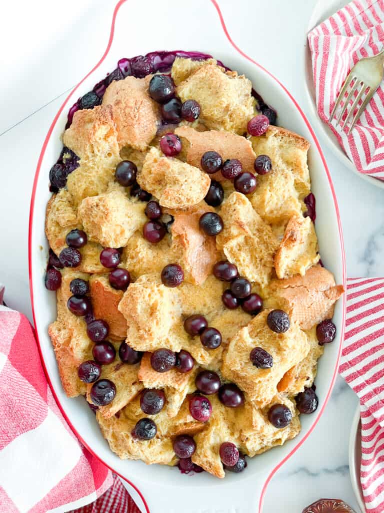 Finished baked french toast casserole in a white dish with red accents.