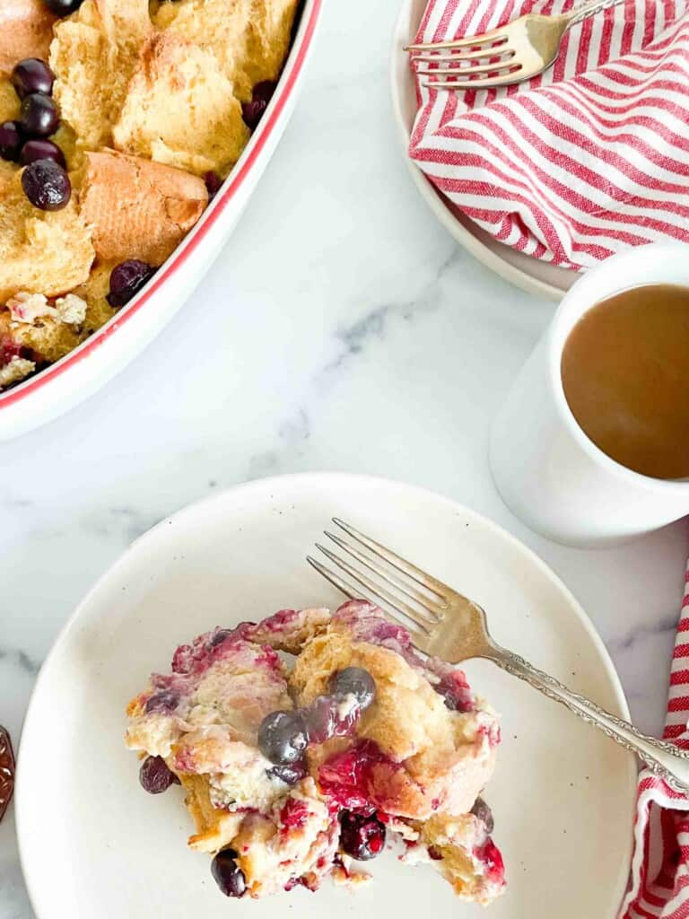 Breakfast table with french toast casserole, a breakfast plate, and coffee cup. 