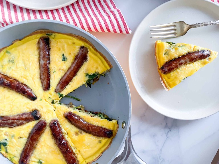 Sausage frittata in a skillet and on a plate.