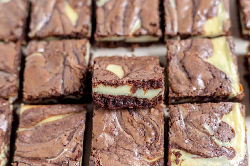 Cheesecake brownies showing its layers and swirls.