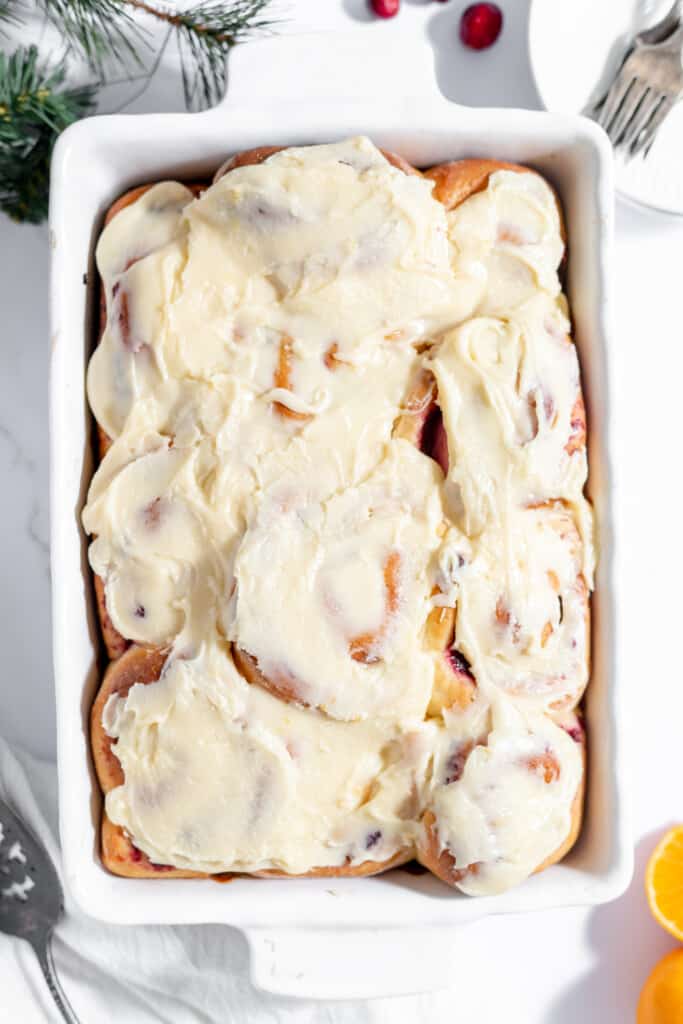 Orange Cranberry rolls frosted in a pan. 