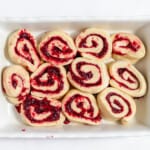 Sliced cranberry orange rolls in a baking dish ready to rise.