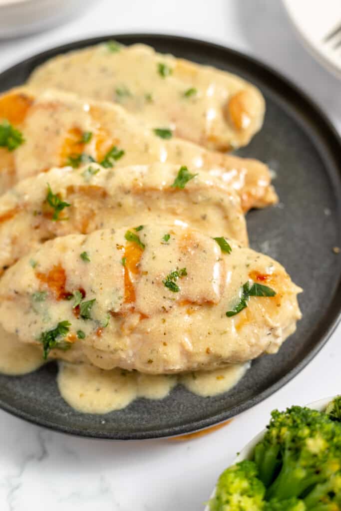 Creamy Ranch Chicken breasts with gravy on a plate.
