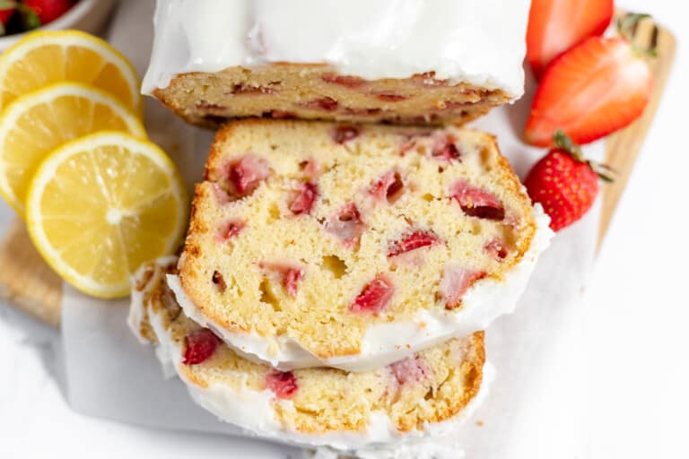 Sliced loaf of strawberry bread with visible chunks of strawberries.