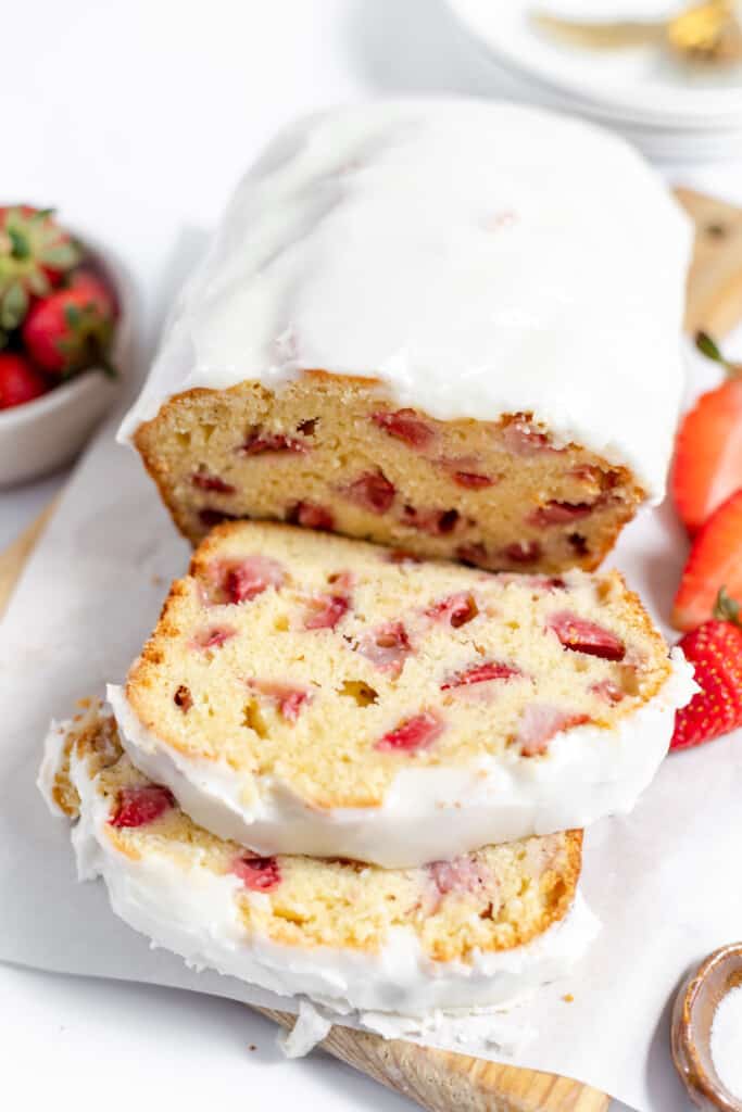 Sliced strawberry quick bread with icing. 