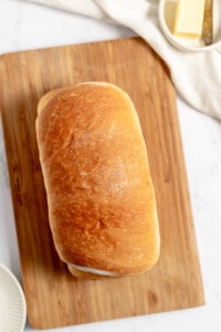 Finished loaf of cinnamon swirl bread on a cutting board.