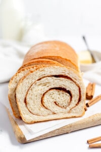 Cinnamon swirl bread sliced on a cutting board.