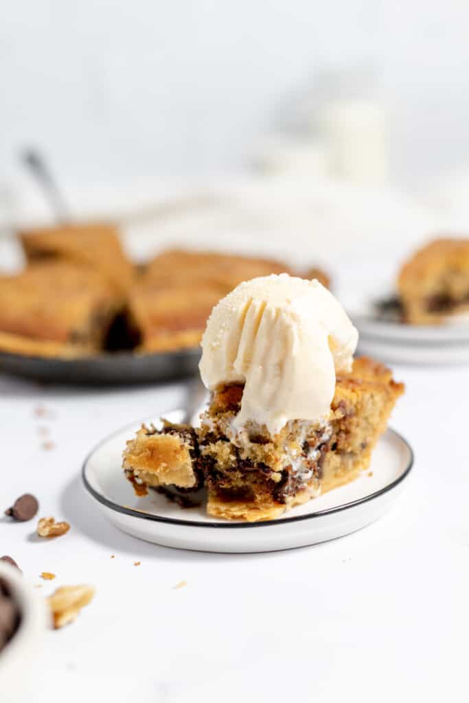 Pie with ice cream and a bite take out of it.