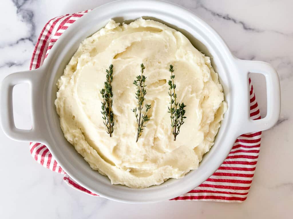 Mashed potatoes garnished with thyme.