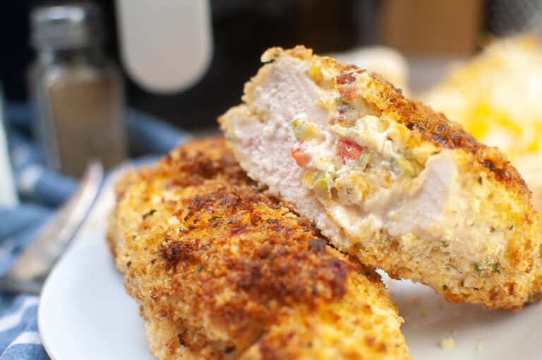 Close up of an air fryer stuffed chicken breast cut in half.