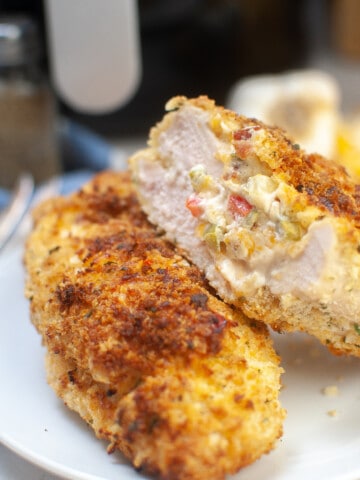 Stuffed chicken breast, one cut in half so you can see the inside.
