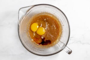 Brown sugar, eggs, oil, and vanilla in a bowl.