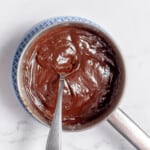 Cooling ganache with a spoon.