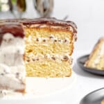 Cannoli Cake with a slice cut out of it.