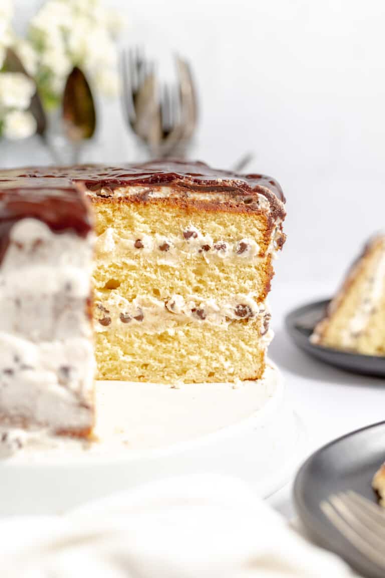 Cannoli Cake with a slice cut out of it.