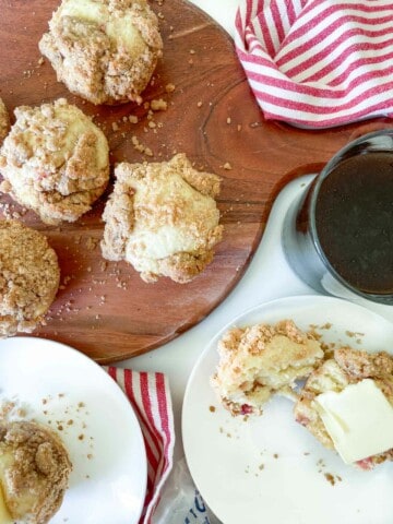 Rhubarb Muffins on a round board with muffins on plate.