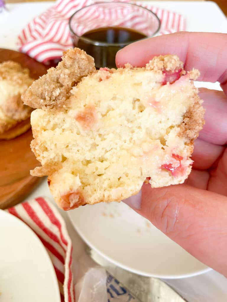 Rhubarb muffin split in half with butter on it.