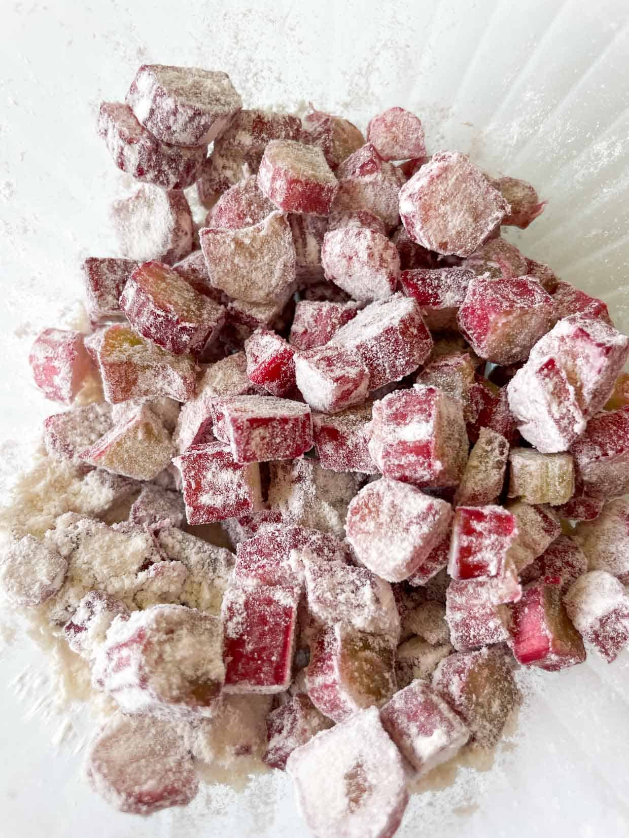 Coating the rhubarb slices with flour.