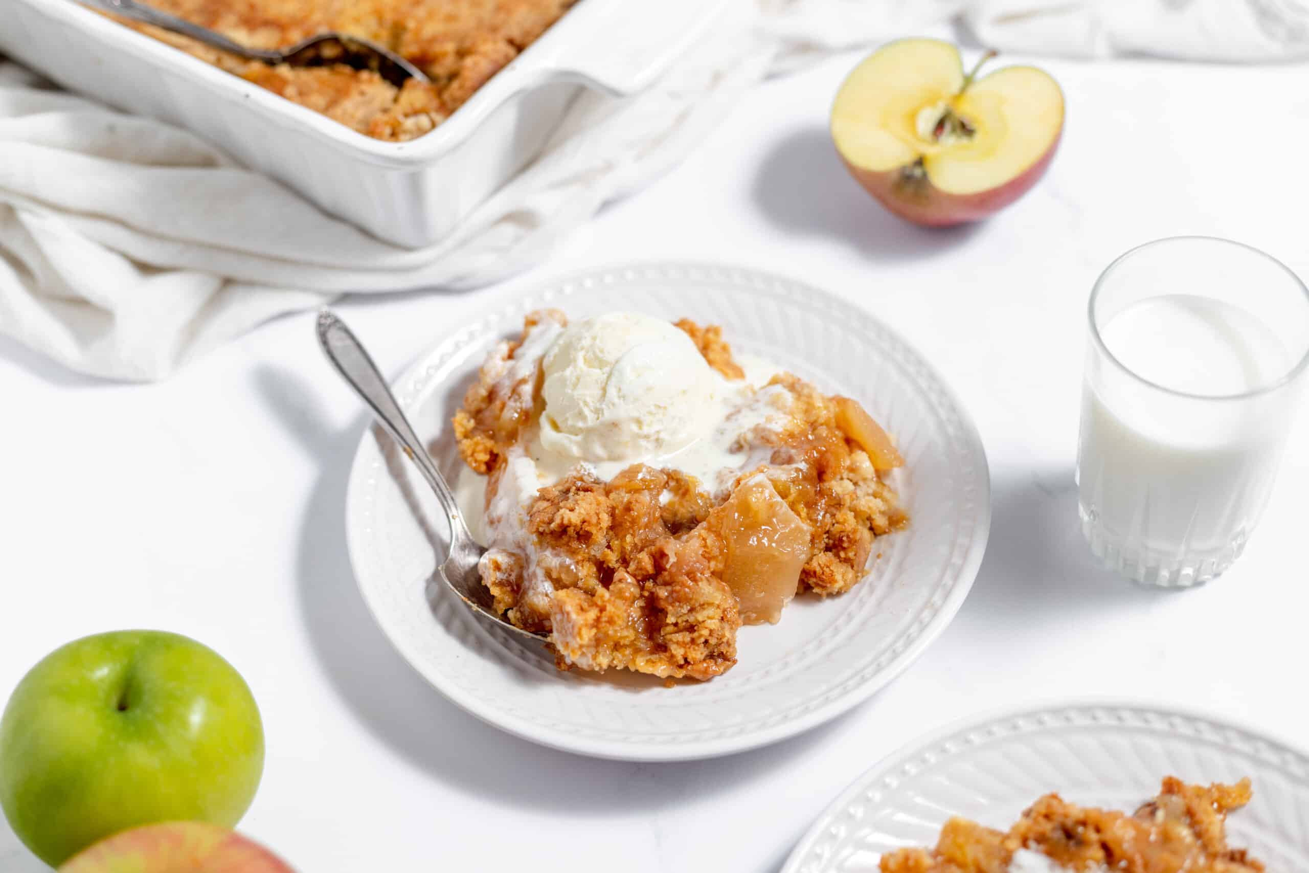 A bowl of cake with ice cream on top.