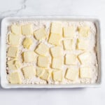 Butter squares in a white baking dish.