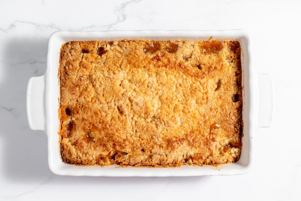 A square baking dish with a piece of bread in it.