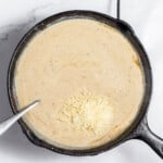 Adding cheese into the gravy.