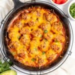Cheesy enchilada meatballs cooked in a skillet.