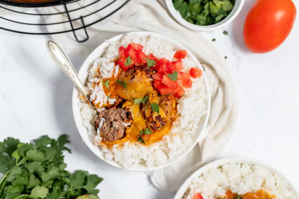 Enchilada meatballs served with rice and tomatoes.
