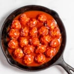 A skillet filled with enchilada meatballs.