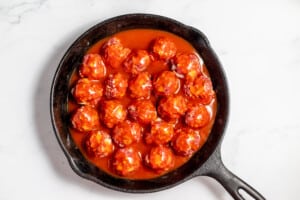 A skillet filled with enchilada meatballs.