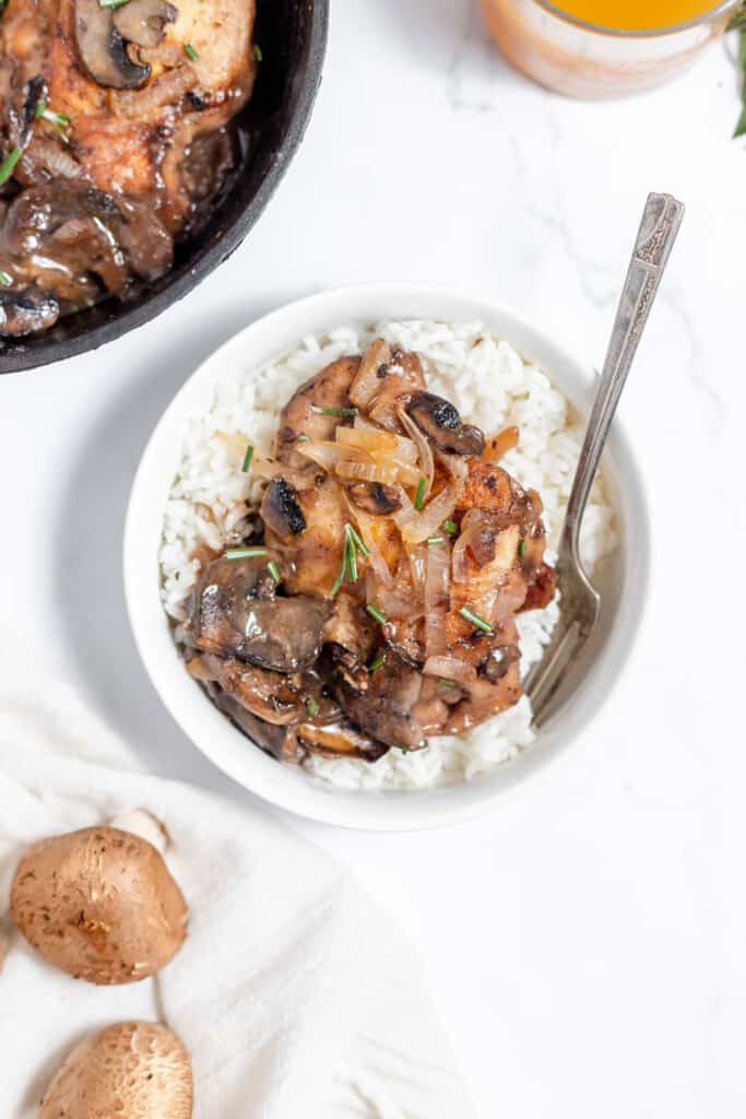 A bowl of Chicken Marsala with rice.