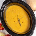 Squash soup in a slow cooker with apples and spices.