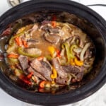 A crock pot full of meat and vegetables.
