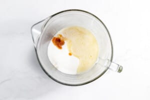 A glass bowl with a melted butter mixture in it.