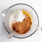 A glass bowl with flour, sugar, and cinnamon in it.