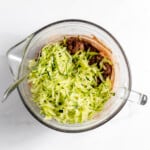 Shredded zucchini in a bowl to make brownies.