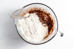 A bowl with flour, eggs, and other ingredients.