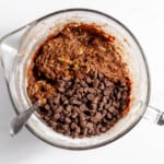Chocolate chip cookie batter in a mixing bowl.