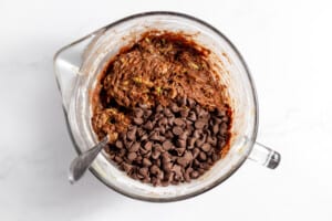 Chocolate chip cookie batter in a mixing bowl.