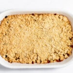 A white baking dish with a crumble topping.