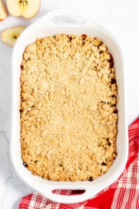 Apple crumble in a white baking dish.