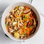 A pot filled with vegetables and mushrooms.