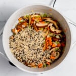 A pot filled with vegetables and rice.