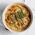 A pot filled with mushrooms and sage.