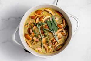 A pot filled with mushrooms and sage.