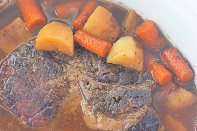 Slow cooker beef stew with carrots and potatoes.