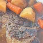 Slow cooker beef roastwith carrots and potatoes.