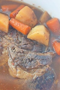 Slow cooker beef roastwith carrots and potatoes.